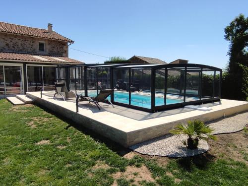 a house with a swimming pool in a glass house at la bouquetiere in Mazières-en-Gâtine