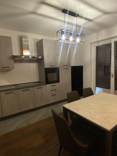 a kitchen with a table with chairs and a light at Ft House in Castel di Sangro