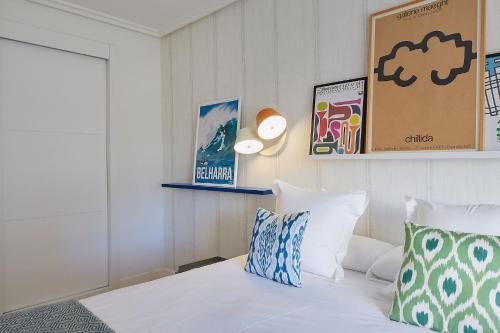 a bedroom with a white bed with two pillows at ATeRIAN EUROMAR I in Zarautz