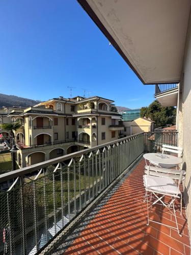a balcony with a table and chairs and buildings at Fior&Iris Apartments in Stresa
