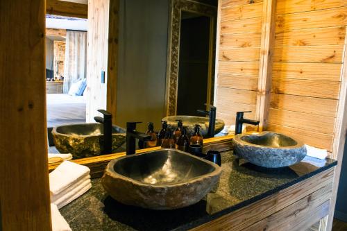 a bathroom with three sinks and a mirror at TimBila Safari Lodge in Omaruru