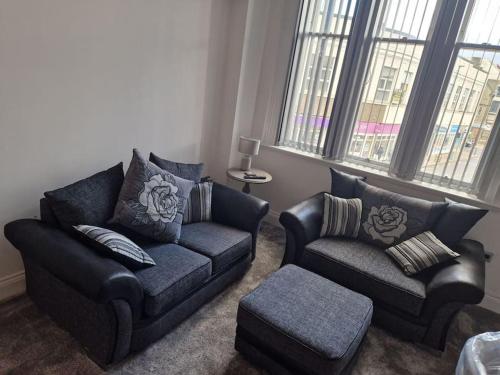 a living room with two chairs and a couch at The Old Ship Hotel, apartment 2 in Skipton