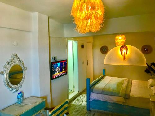 a bedroom with a bed and a tv and a mirror at Hotel Barba in Urla
