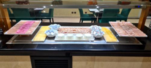a table topped with different types of pastries at Hotel Borj Rabat - A member of Barceló Hotel Group in Rabat