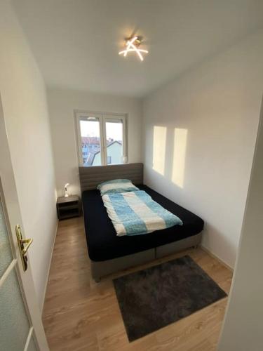 a small bedroom with a bed and a window at City Apartment Tulln in Tulln