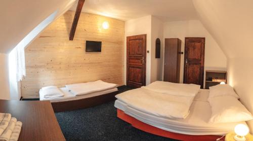 a bedroom with two beds in a room at Penzion Lenora in Lenora