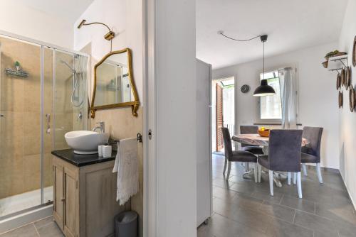 a bathroom with a shower and a sink and a table at Casa Lydia in Rio nellʼElba