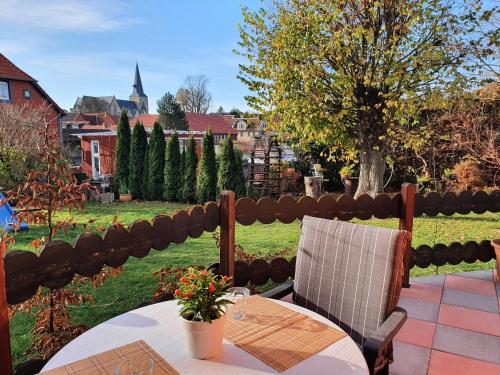 a table and chairs on a patio with a yard at Ferienhaus Petra in Elbingerode