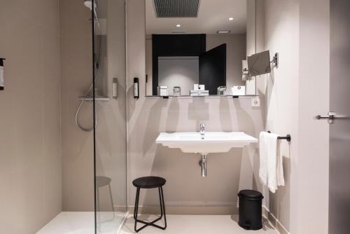 a bathroom with a sink and a glass shower at Soho Boutique Palacio de Pombo in Santander