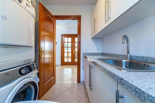 a kitchen with a sink and a washing machine at 88-Exclusive Villa with Private Pool in Mijas, Malaga in Mijas