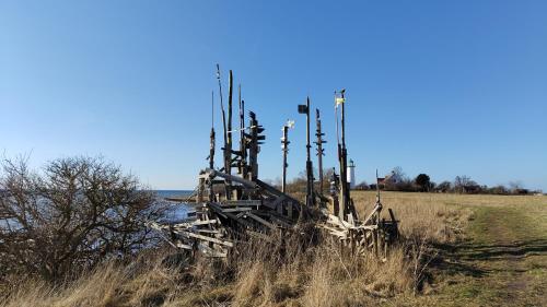 a wooden structure in the middle of a field at Rosdala gård - gästhuset in Rydsgård