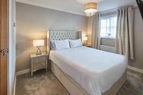 a bedroom with a large white bed and a window at Host & Stay - Aidan Gardens in Durham