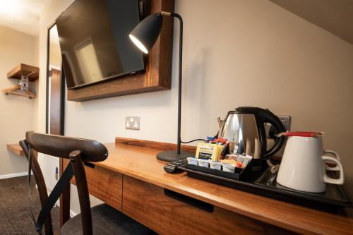 a desk with a tea kettle and a lamp on it at The Springfield Inn by Innkeeper's Collection in Lowdham