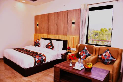 a hotel room with a bed and a couch at Travel Soul By Saif in Sawāi Mādhopur