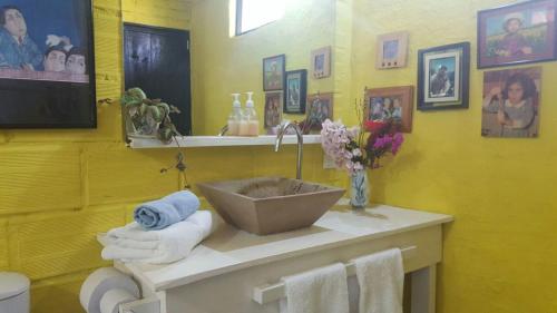 a bathroom with a sink and towels on a counter at Casas La Colina in Curití