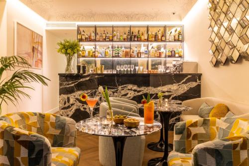 a bar with two tables and two chairs at Nerva Boutique Hotel in Rome