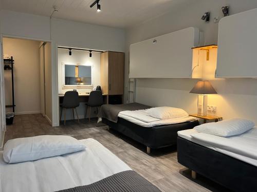 Un pat sau paturi într-o cameră la Hotel Amado