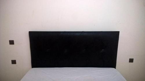 a black headboard of a bed in a room at Villa Cat Doudou in Tangier