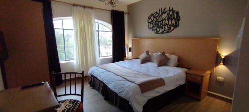 a bedroom with a large bed and a window at Moab Hotel & Restaurant in Madaba