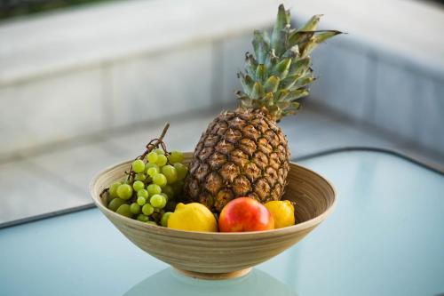 a bowl of fruit sitting on top of a table at Paloma Luxury Studios in Panormos Kalymnos
