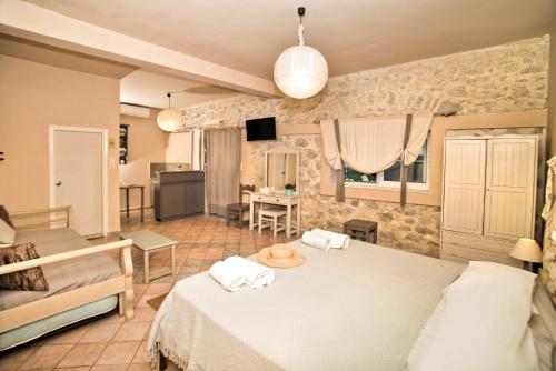 a bedroom with two beds and a living room at Paloma Luxury Studios in Panormos Kalymnos