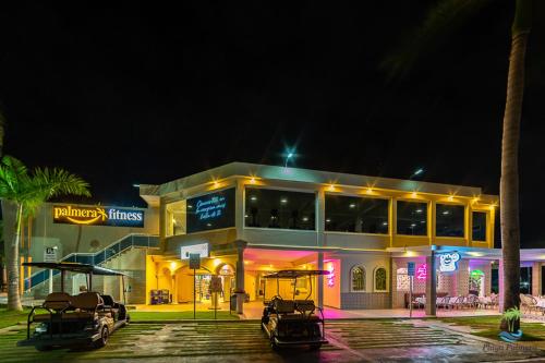 a building with cars parked in front of it at night at Playa Palmera Beach Resort in Punta Cana