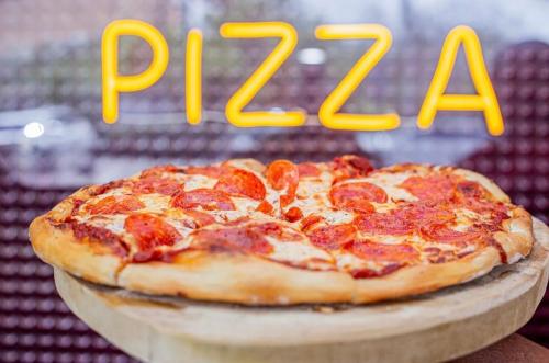 a pepperoni pizza sitting on top of a cutting board at Playa Palmera Beach Resort in Punta Cana