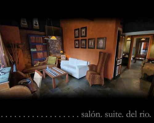 a living room with a couch and a table and chairs at Casona Camino Real De Selores in Selores