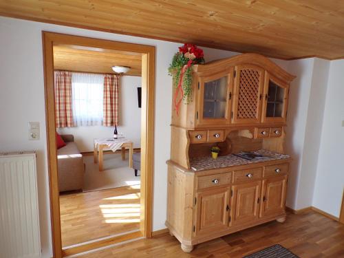 a kitchen with a large wooden cabinet in a room at Landhaus Müller in Bad Birnbach