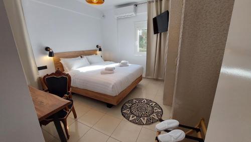 a bedroom with a bed and a table and a desk at NisoVillas in Volos