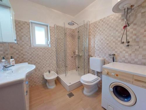 a bathroom with a shower and a toilet and a sink at Apartment Durda in Senj