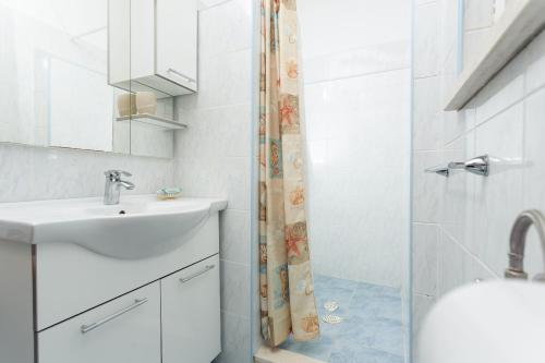 a bathroom with a sink and a shower at House Ivo in Stomorska