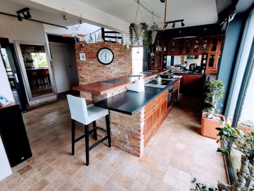 a kitchen with a clock on a brick wall at House of Freedom with Sea View and Sauna in Osłonino