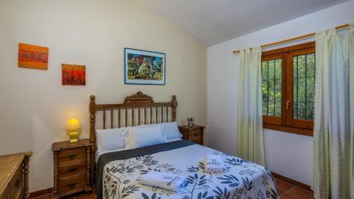 a bedroom with a bed and a window at Almendros Antequera - Los Nogales by Ruralidays in Antequera