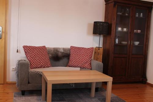 a living room with a couch and a coffee table at Holzer-Hof in Au