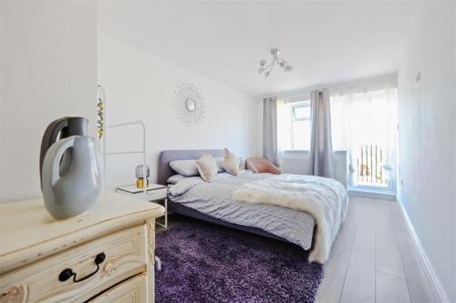 a bedroom with a bed and a tv in it at Stunning family home, walking distance to Herne Bay Beach! in Kent