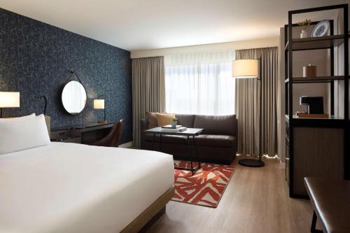 a hotel room with a bed and a couch at Hyatt Regency San Antonio Riverwalk in San Antonio