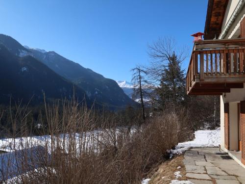 a balcony of a house with a view of a mountain at Apartment Deli by Interhome in Alvaneu