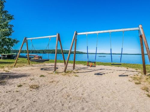 an empty swing set in the sand near the water at Holiday Home Joutiainen l 69 in Hara