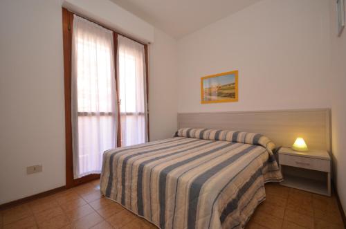 A bed or beds in a room at Residence Valbella