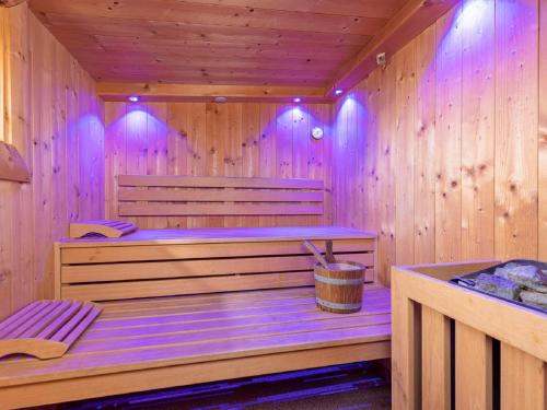 a wooden sauna with a bucket in it at Holiday Home Lindenalm by Interhome in Schwendau