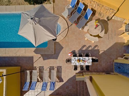 a painting of a swimming pool with an umbrella and chairs at Villa Villa Acuario by Interhome in Calpe
