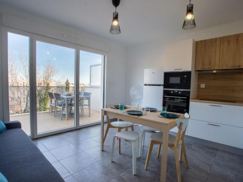 a kitchen and living room with a table and chairs at Apartment Indigo Bay by Interhome in Le Lavandou