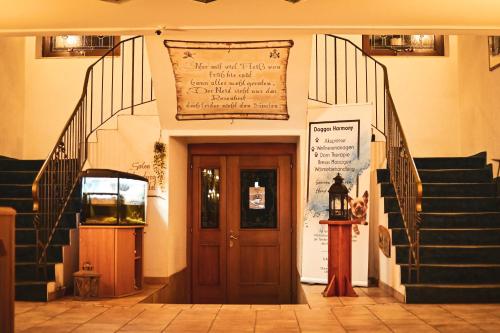 a entrance to a building with stairs and a door at Berghotel Steiger - Erzgebirge in Schneeberg