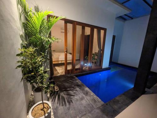 a room with a blue floor with plants in it at Bright Peaceful Villa in Kerobokan
