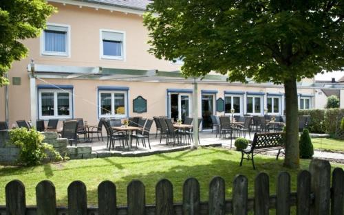 a patio with tables and chairs in front of a house at Landgasthof Schwabenpfanne in Erbach