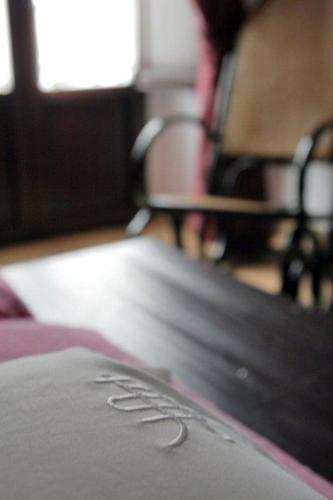 a close up of the word hotel written on a table at La Posada Del Infante in La Puebla de los Infantes