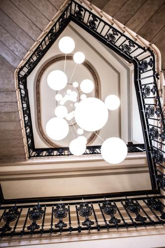 a mirror hanging on a wall with chandeliers at Radisson Collection Hotel, Palazzo Touring Club Milan in Milan