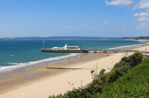 a view of a beach with a pier and the ocean at Stylish Flat in Bournemouth Town Centre in Bournemouth