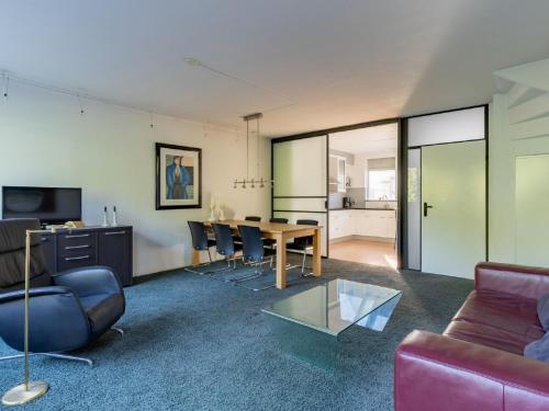 a living room with a table and chairs at Apartment in Alkmaar with sea beach in Alkmaar